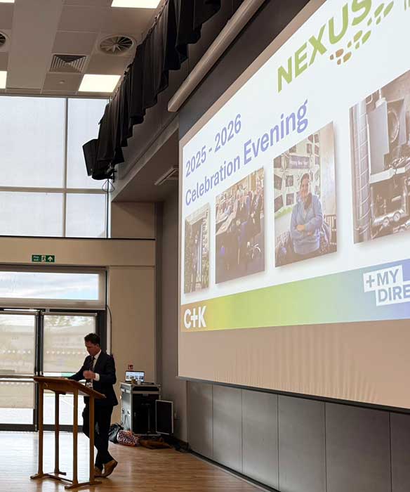 Staff member from Benton Park at the Nexus celebration evening talking to families